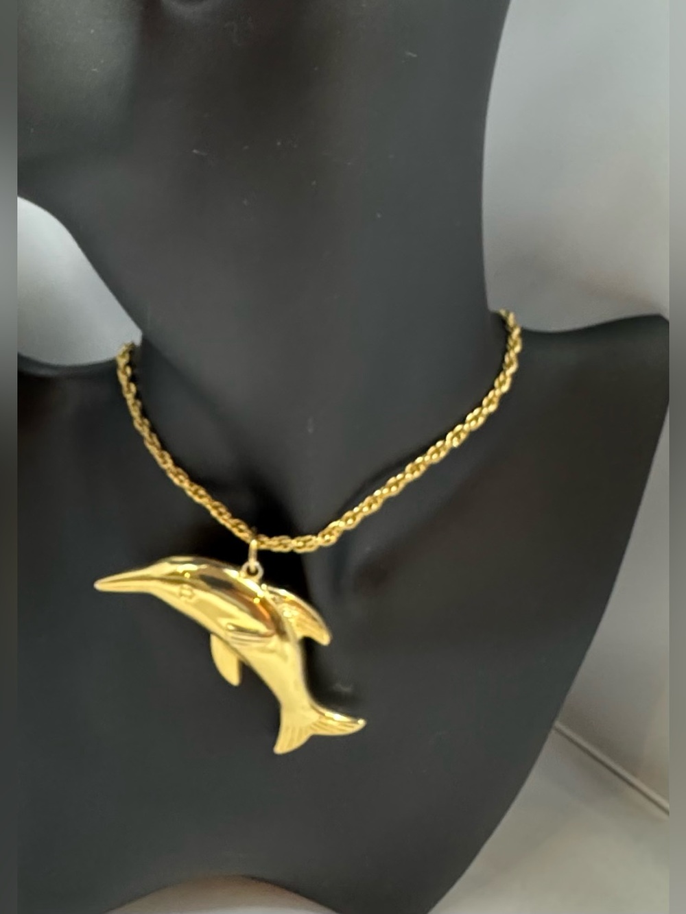 Vintage chain with a dolphin pendant.